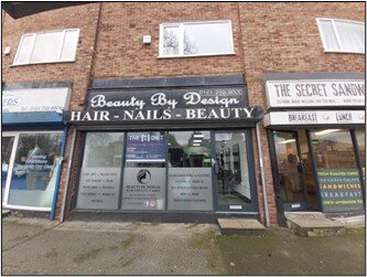 Front elevation of the commercial terrace at 46 Crumpsall Lane, Manchester, showing the shopfront of "Beauty By Design" hair and beauty salon.